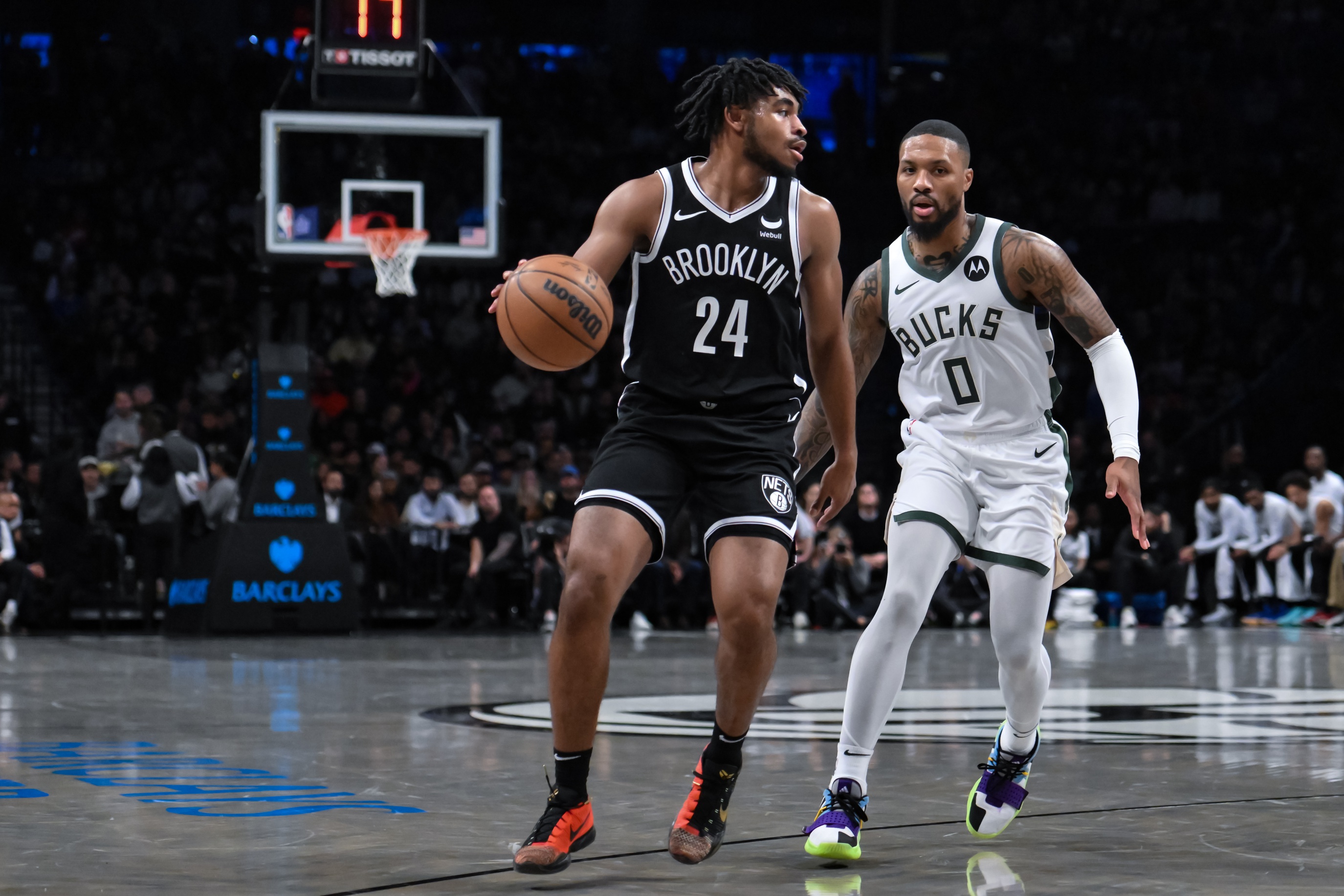 Brooklyn Nets guard Cam Thomas (24) looks for an opening against Milwaukee Bucks guard Damian Lillard (0)